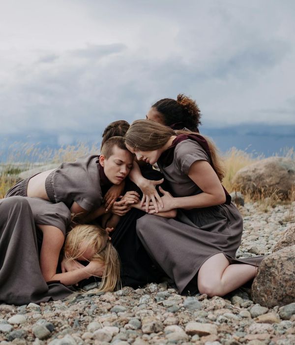 Woman performing a fluid, gentle movement in a bright, calm space.